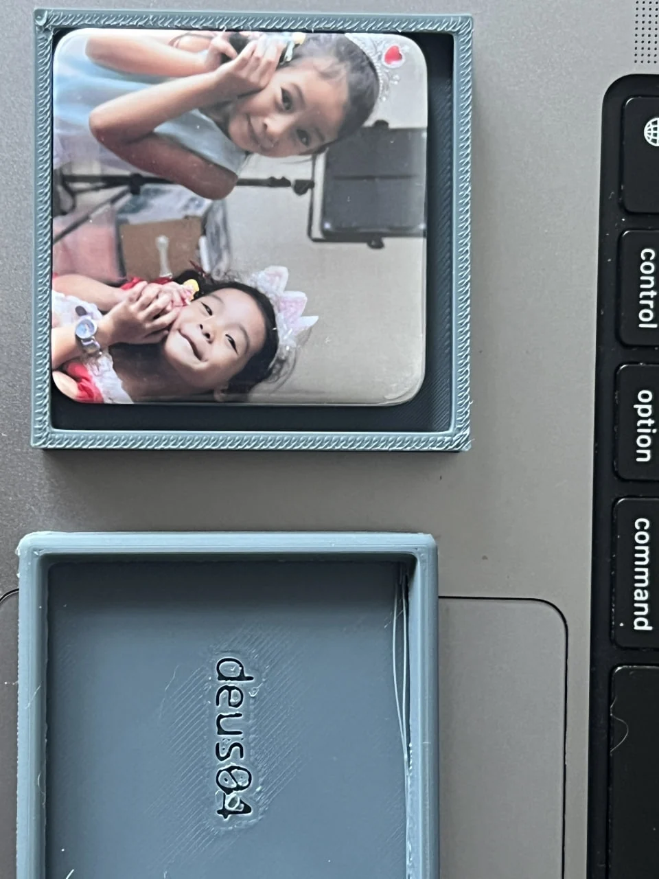 The first photograph fitted into the rough grey prototype on a laptop