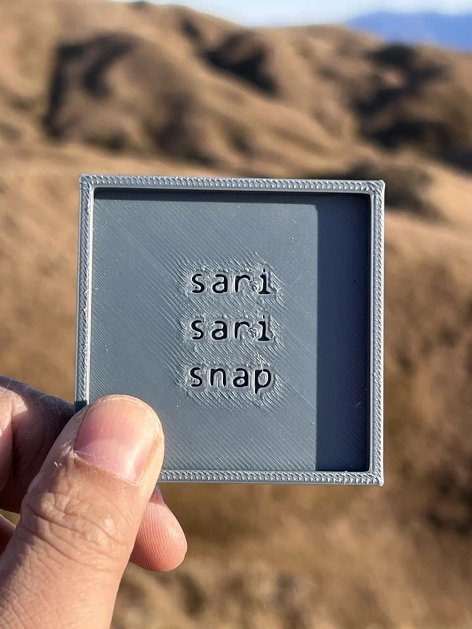 Close view of the rough grey prototype with a decorative edge and SariSari Snap lettering