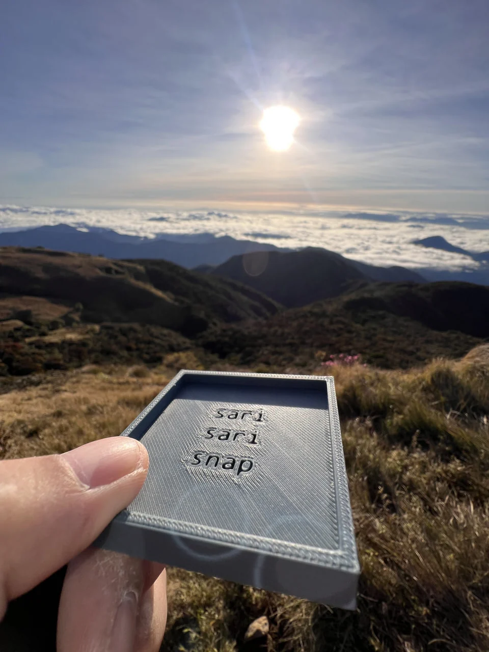 The first rough grey SariSari Snap held above the landscape at Mt. Pulag